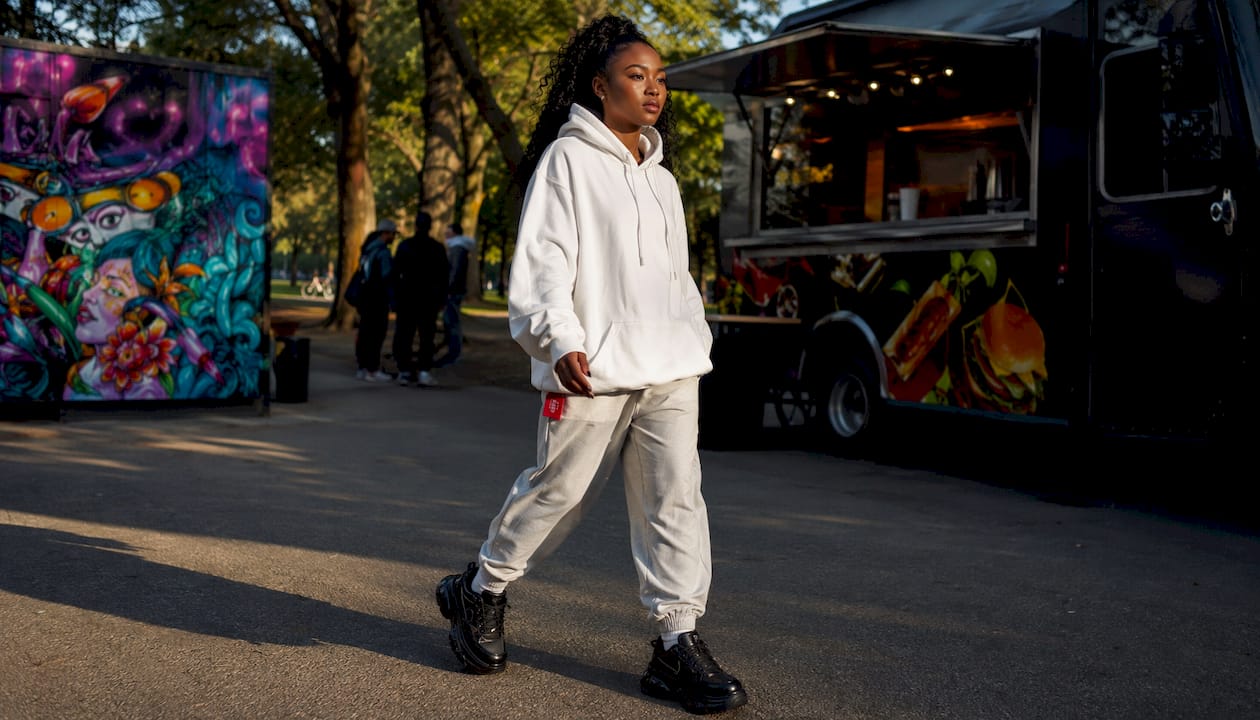 Woman wearing oversized graphic tee and cargo pants outdoors